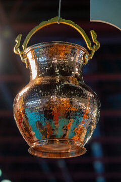 Metal coffee cezve with decorative oriental pattern on the shop window. Household items copper items for sale. Cupric coffe epots at the bazaar in Antalya Turkey. Turkish coffee pots. Metal coffee cez