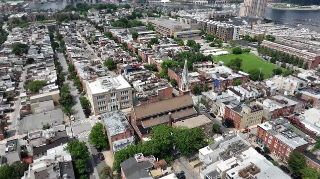 Riverside, Maryland, USA - June 9, 2025: A historic church stands alongside row houses in the beautiful Riverside neighborhood.