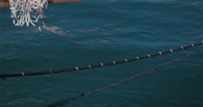 Close up of a rope stretched above the water in Rovinj, Croatia.