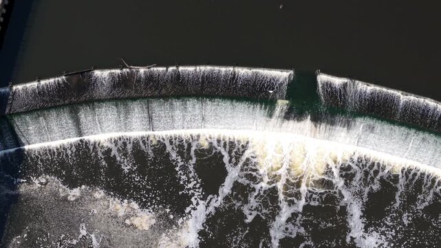 Aerial view of Knottingley Weir and Hydroelectric Power Plant with white foam and rushing water in Knottingley, England, United Kingdom.