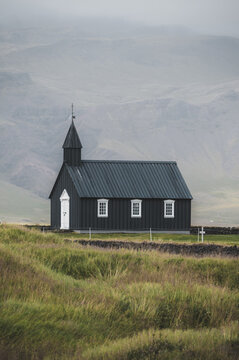 Closeup shot of Black Church, Iceland landmark. Budir, Snaefellsnes peninsula. Autumn or summer colours. Travel and tourism vertical banner