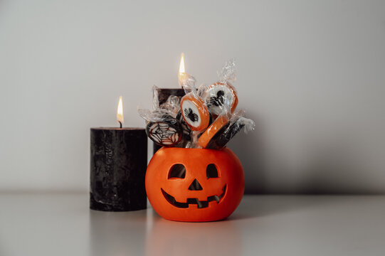 Copy space halloween banner, candle,treats against grey background