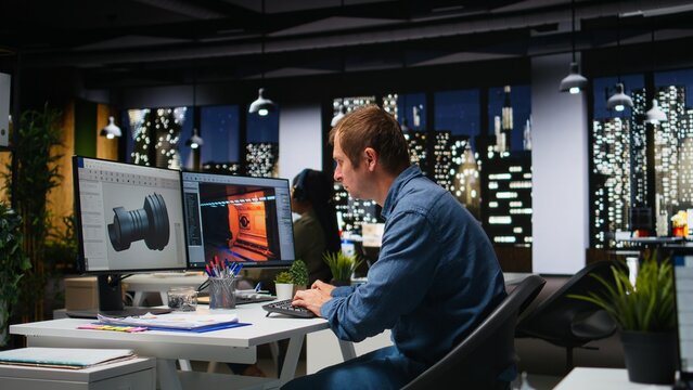 Male IT engineer uses AI techniques to create video game and a turbine, futuristic gaming design for a Mars station project. Sci fi system for a modern game lobby, professional software. Camera A.