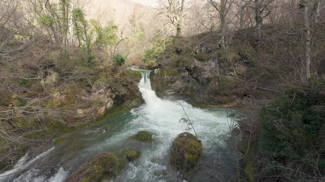 Scenic waterfall flowing down the river in the forest