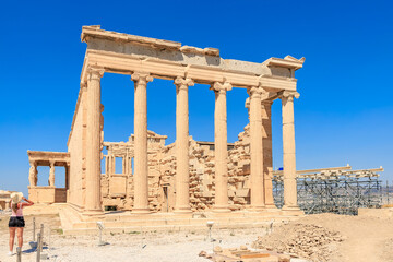 Fototapeta premium A large building with columns and a blue sign, Acropolis in Athens
