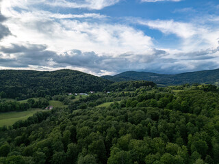 Obraz premium Drone panorama of rural landscape near Zenting in Bavarian Forest with dramatic clouds and green hills