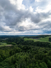 Obraz premium Drone panorama of rural landscape near Zenting in Bavarian Forest with dramatic clouds and green hills