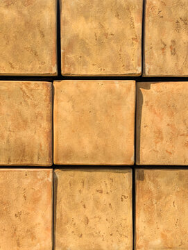 A pattern of stacked terracotta pots that create a textured design with natural earth tones