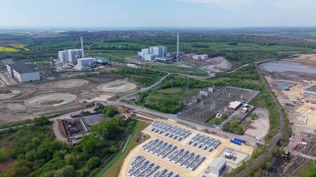 Aerial view of Ferrybridge Battery Energy Storage Systems with industrial infrastructure and green fields in Knottingley, England, United Kingdom.
