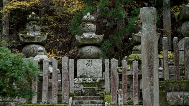 Stone Jizo Bosatsu Statue Wearing Red Bib in a Japanese Temple Garden