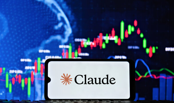 The Claude logo is displayed on a smartphone screen with a stock market chart in the background. Technology, computing and business concept.