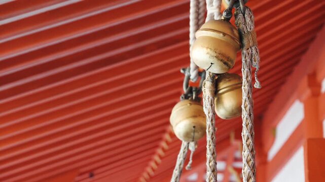 Traditional Japanese Hanging Bells Under Shrine Roof