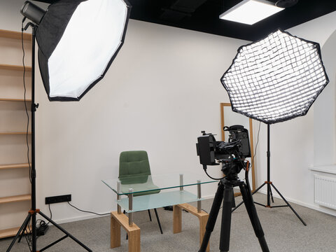 Camera on tripod with lighting equipment prepared for recording