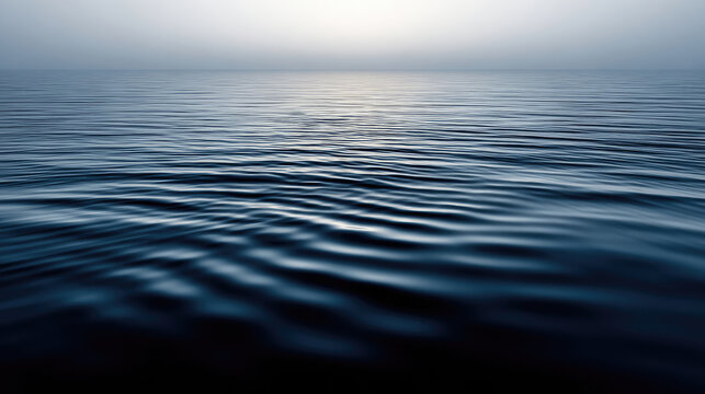Serene ocean surface with gentle ripples reflecting soft light.