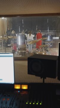 Music studio scene. Musicians practicing with mixing and recording gear