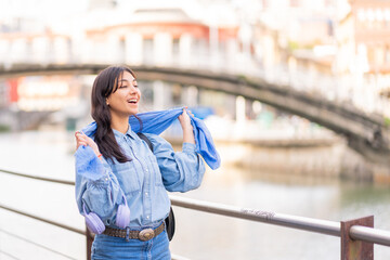 Fototapeta premium Young woman smiling laughing with scarf outdoors