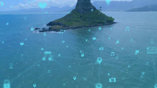 Drone pulling back over sea, island centering, hologram icons forming network to show connectivity