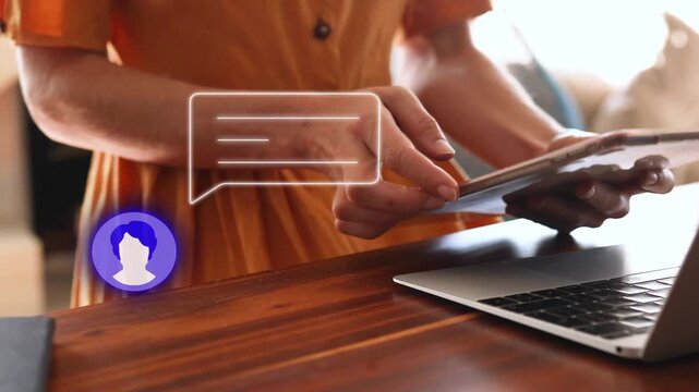Woman typing on laptop, reacting to incoming tech chat bubble overlay and tapping tablet to reply