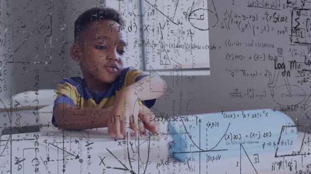 Boy leaning, touching blue toy, pushing while holding pencil, math overlays showing motion learning