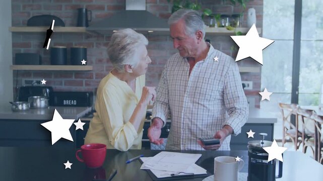 Man showing phone couple reviewing finance docs and cheering as star graphics float across frame