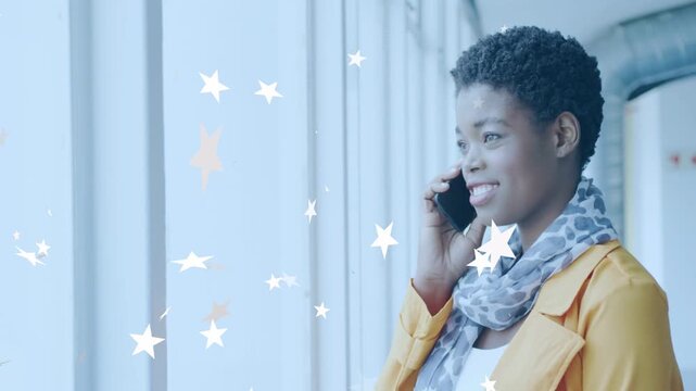 Woman holding phone by window, call ringing, increasing star overlays crossing face, for marketing