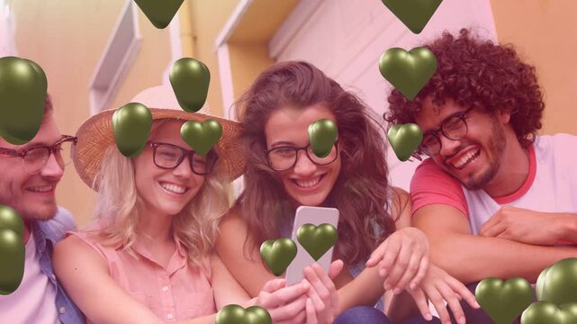 Friends sitting on steps, center woman tapping phone, creating 3D hearts and reacting for tech