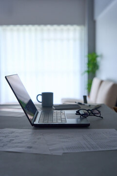 Programming code displayed on laptop screen on dark desk