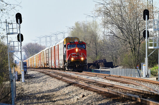 Canadian National Railway locomotives lead a freight train norththbound as it exits a passing siding in southwest suburban Chicago.