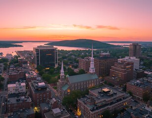 Obraz premium Aerial view of Burlington Vermont skyline at sunset over Lake Champlain.