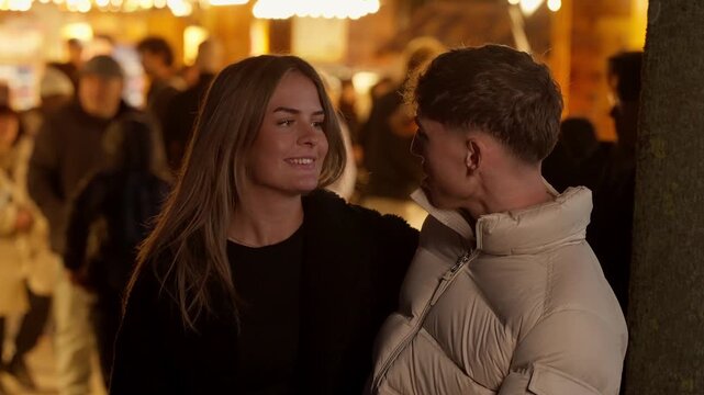 A young couple embraces in Paris at night with warm lighting and a bokeh background The scene captures a romantic and candid moment of love and connection in the city The couple is dressed for winter 