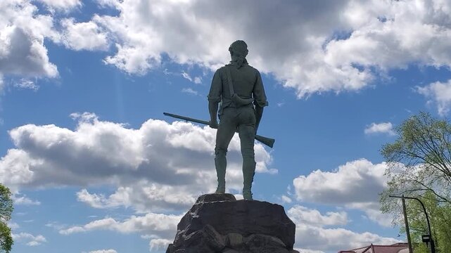 The famous statue of the Revolutionary War minuteman stands tall on Lexington Battle Green. It is here the Revolutionary War started in 1775. America 250th Birthday. Lexington, MA on May 07, 2026