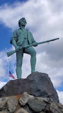 The famous statue of the Revolutionary War minuteman stands tall on Lexington Battle Green. It is here the Revolutionary War started in 1775. America 250th Birthday. Lexington, MA on May 07, 2026