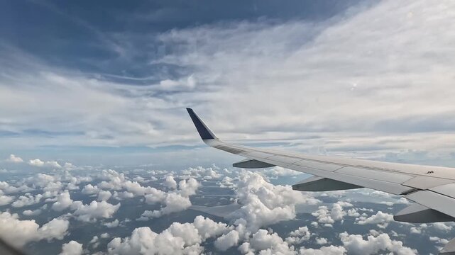 Stunning aerial view of fluffy white clouds from airplane window during flight