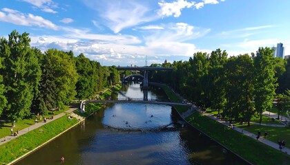 Fototapeta premium Aerial View Of A Scenic City Park Canal With Green Trees And Multiple Bridges Under A Bright Blue On A Sunny Summer Day