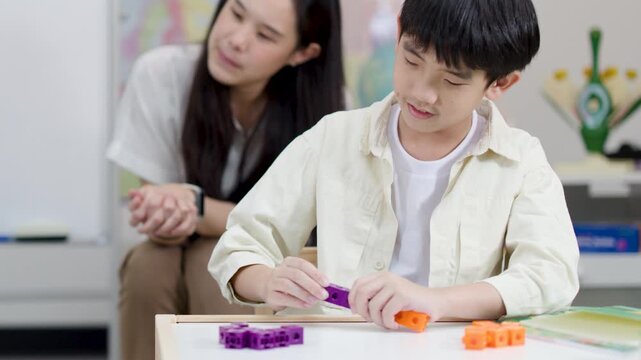 Thai Elementary Student Learning Math with Colorful Counting Blocks in Classroom