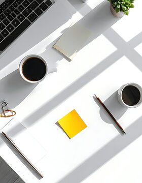 A cluttered white desk with office supplies and drinks