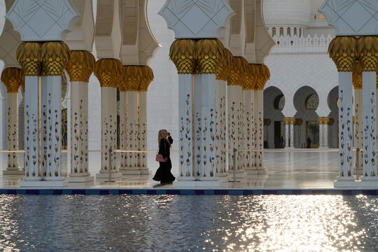 View of the ornate white marble columns with gold leaf capitals and intricate floral designs at the Sheikh Zayed Grand Mosque in Abu Dhabi, Abu Dhabi, United Arab Emirates.