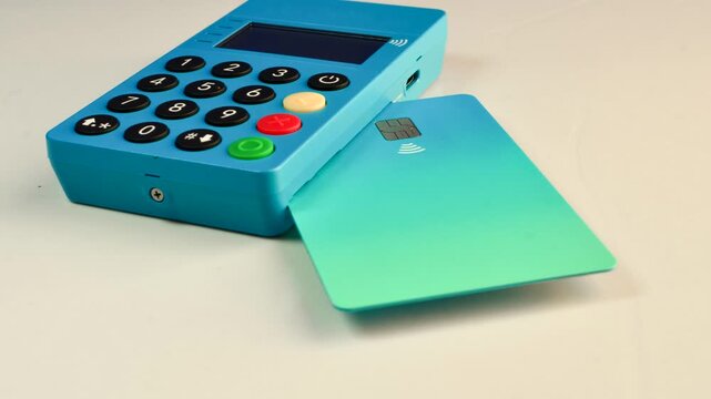 Mini blue card machine on a flawless surface, perfect for hassle-free transactions. The mini blue card machine rests elegantly on a smooth surface, promoting streamlined transactions.