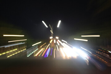Nighttime blur captures speeding traffic on a highway. Bright streaks of lights rush toward a distant vanishing point. Motion conveys speed, urgency, and modern urban life. Ideal for themes of travel © uniqephoto
