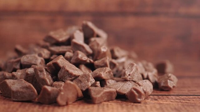 Chocolate pieces stacked on wooden surface