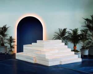 Fototapeta premium Minimalist Stone Reception Desk with Stepped Design in Luxury Hotel Spa Interior Featuring Arched Wall Niche, Lush Potted Plants, and Navy Marble Floor with Copy Space