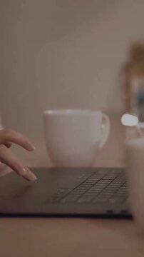 Typing on Laptop with Coffee Cup Background in Cozy Workspace, Remote Working and Productivity Lifestyle Concept