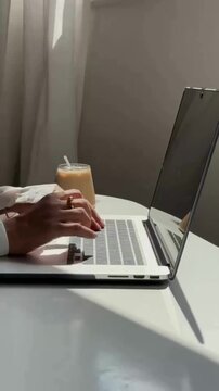 Opening Laptop and Typing Work Beside Latte Coffee in Cozy Workspace, Modern Remote Working and Productivity Concept