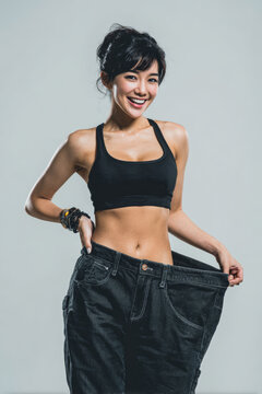 Weight loss asian woman fitness smile oversized pant weight loss success healthy body slim waist happy confident