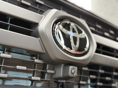 Moscow, Russia, JAN. 3, 2026: Close-up Toyota RAV4 2.0 CVT AWD logo, emblem. Black Toyota RAV4 front side, hood, radiator grille. Japan SUV car Toyota RAV4 V chrome logo on radiator grille close-up. 