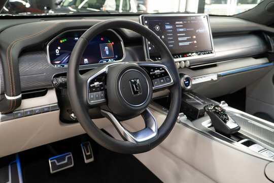 Luxury interior of a Tank 700 Е1 Edition One 3.0T V6 Hybrid 9AT 4WD. Leather interior, steering wheel, dashboard, gear shifting, armrest, front seats. Chinese automobile brand, of a Great Wall Motors.