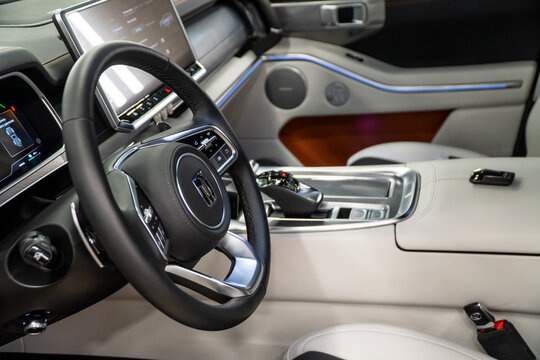 Luxury interior of a Tank 700 Е1 Edition One 3.0T V6 Hybrid 9AT 4WD. Leather interior, steering wheel, dashboard, gear shifting, armrest, front seats. Chinese automobile brand, of a Great Wall Motors.