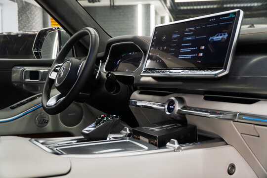 Luxury interior of a Tank 700 Е1 Edition One 3.0T V6 Hybrid 9AT 4WD. Leather interior, steering wheel, dashboard, gear shifting, armrest, front seats. Chinese automobile brand, of a Great Wall Motors.