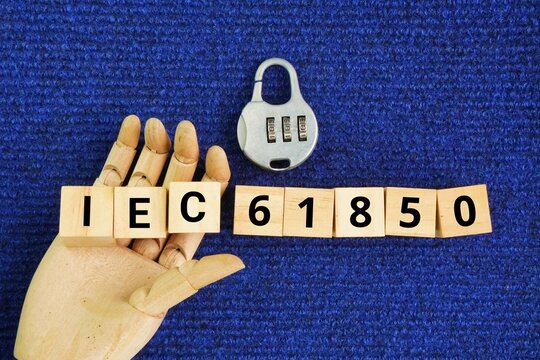 Wooden cube and key with the words IEC 61850 is an international standard for electrical substation automation, enabling interoperability among Intelligent Electronic Devices