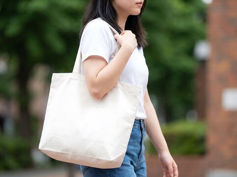 Blank White T-Shirt and Canvas Tote Bag Mockup Female Model Walking Urban Street